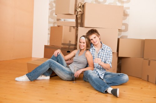 Professional furniture movers handling a sofa in Islington